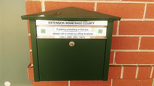 Photo of green metal drop-box outside the JPCC staff entrance.