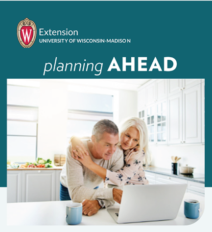 Older aged couple embracing while doing end-of-life planning on a laptop.