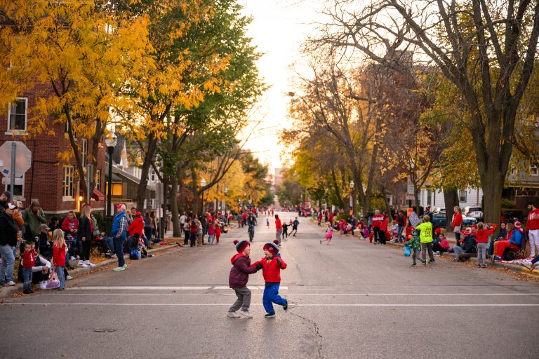 outdoor event with families and young children gathered in the street