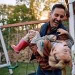Father playing with his daughter in the backyard