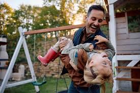 Father playing with his daughter in the backyard