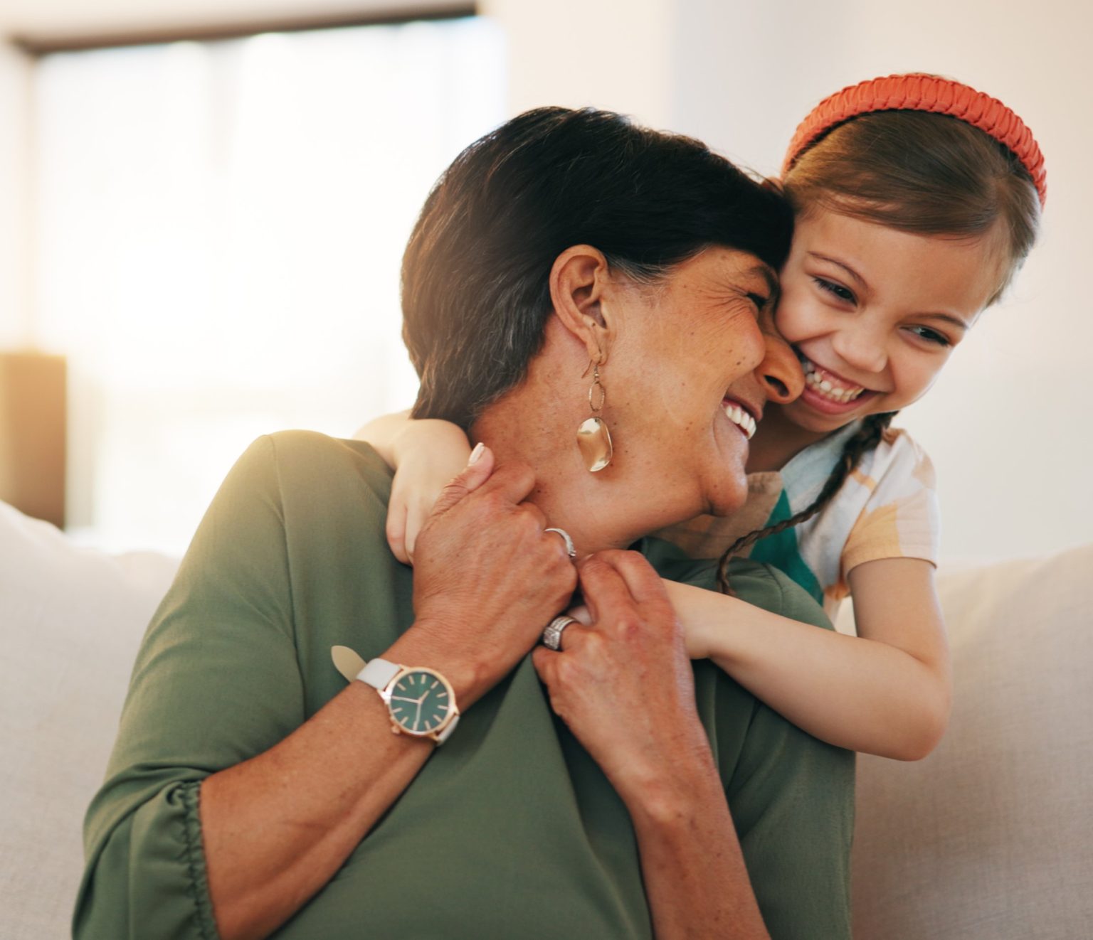 female caregiver being embraced by a young girl